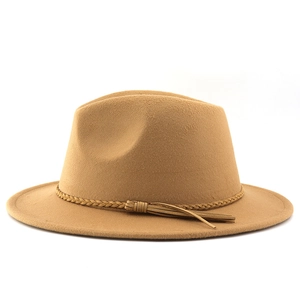 Detail of camel fedora hat featuring woven band and elegant tassel accents on brim