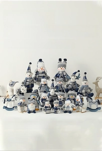 Close-up of Nordic style blue and white plaid Christmas plush gnomes and reindeer toys