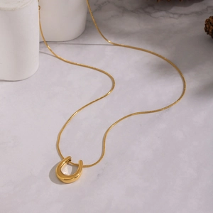 Minimalist U-shaped horseshoe pendant necklace in 18K gold plating with snake chain