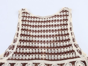 Detail of bohemian hollow crochet pattern in cream and brown on sleeveless knit vest
