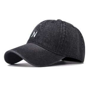 Vintage washed black baseball cap with embroidered white letter N on minimalist cotton crown