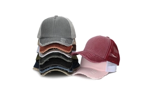 Macro shot of colorful distressed trucker hats with breathable mesh and frayed brims