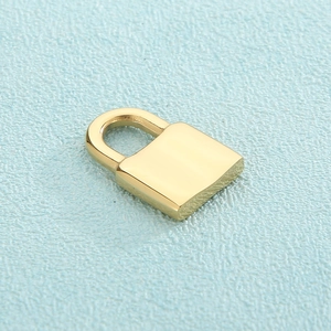 Close-up of polished gold square padlock pendant with smooth metallic finish on blue background