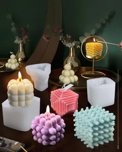 Detailed view of bubble cube silicone molds and finished soft-colored scented candles