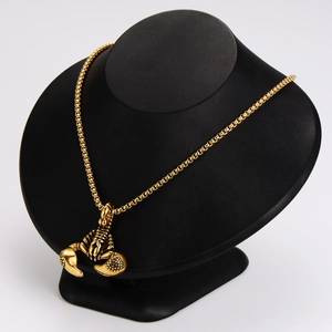 Golden stainless steel scorpion pendant necklace displayed on a professional jewelry bust