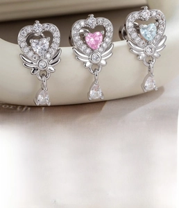 Macro detail of winged heart earrings with water drop zircons in silver titanium steel