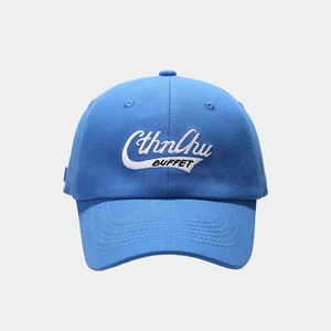 Detailed embroidery of white letters on a blue cotton twill baseball cap