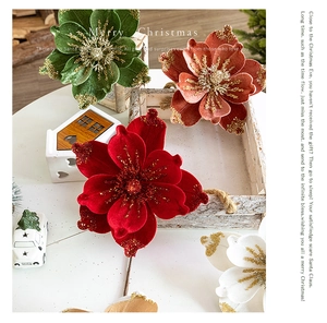 Detailed view of velvet Christmas flowers with golden glitter edges for DIY tree decor