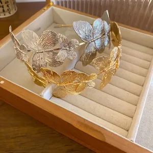 Elegant gold and silver butterfly metal headbands in a premium velvet jewelry box