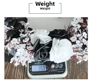 Detailed view of black and white Gothic rose wreath weighing 159g on a scale