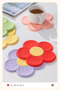 Macro shot of colorful cherry blossom silicone coasters with white mug on tabletop