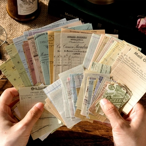 Vintage scrapbooking material set with retro labels held in hand over a desk