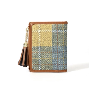 Detail shot of a brown plaid wallet with tassel zipper and refined texture