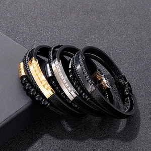 Detail view of woven leather bracelets with silver gold and black metallic beads and clasps