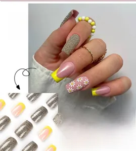 Detail of yellow French press on nails with glitter and daisy floral patterns