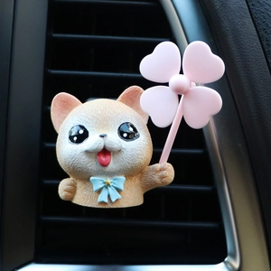 Macro detail of a Pomeranian dog air vent clip with blue bow and pink four-leaf clover