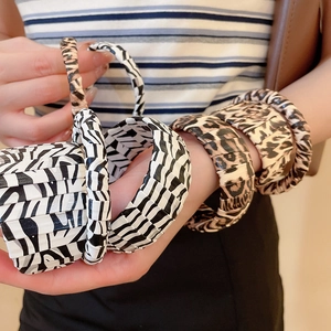 Close-up of zebra and leopard print elastic bracelets with textured animal patterns