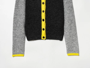 Detail of color-block knit cardigan with lemon yellow trim and single-breasted buttons