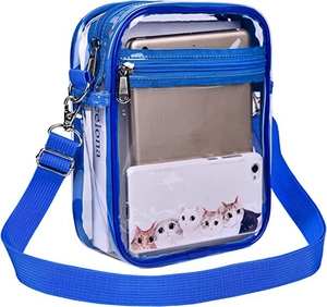 Blue transparent PVC crossbody bag showing spacious interior with tablet and books