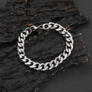 Classic 11mm silver stainless steel Cuban link bracelet for men on textured background