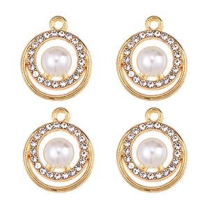 Macro detail of four gold-plated alloy pendants with central pearls and zircon accents