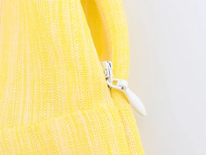 Detail of yellow woven fabric texture with a high-quality white invisible drop zipper