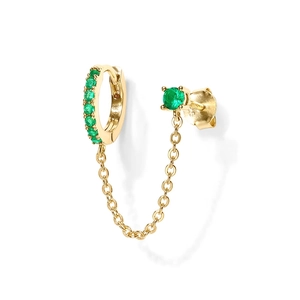 Detail view of gold linked earrings with green gemstones for double ear piercings