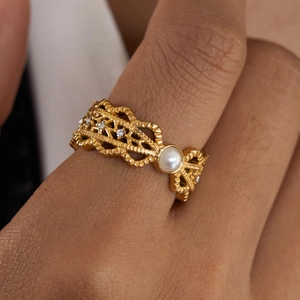 Vintage gold hollow woven ring with central pearl and sparkling zircon stones