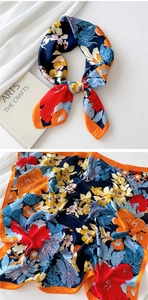 Detailed view of floral satin square scarf with artistic prints and silky texture details