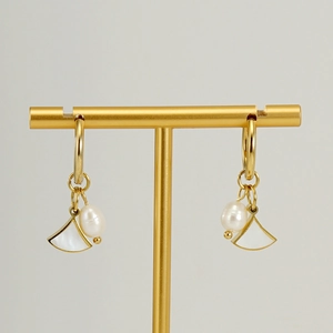 Elegant gold hoop earrings with natural shell fan and pearl pendants on display stand