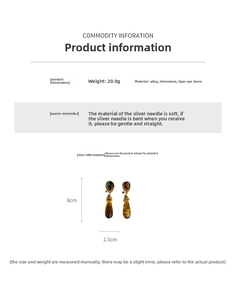 Macro view of vintage tiger eye drop earrings showing 6cm x 1.5cm dimensions and 20.9g weight