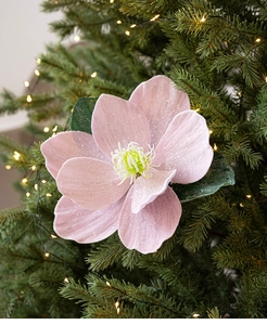 Detailed view of pink magnolia flower decoration with silver glitter on Christmas tree branch