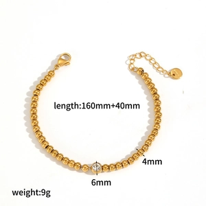 Detail of 18k gold plated tennis bracelet with clear zircon heart and steel beads