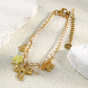 18K gold plated stainless steel bracelet with floral charm and woven rope accents