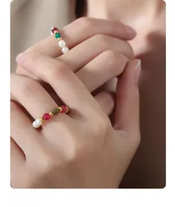 Macro shot of handmade beaded ring with natural pearls, carnelian, and turquoise stones