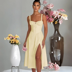 Detail view of a pale yellow slit dress featuring ruched chest and corset waist structure