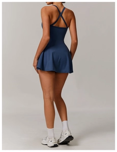 Detail of cross-back straps and pleated hem on blue athletic tennis dress