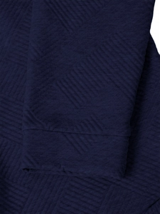 Detailed close-up of dark blue knit hoodie showing textured geometric jacquard fabric pattern