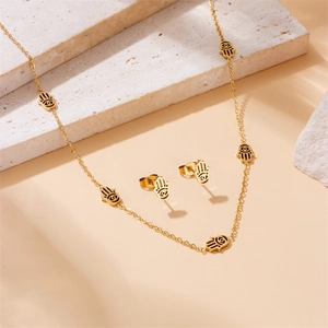 Gold Hamsa Hand jewelry set with evil eye pendants featuring necklace and earrings