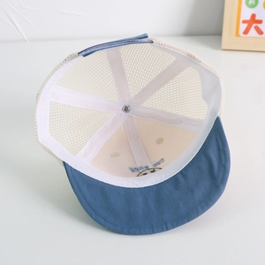Close-up of baby mesh cap showing blue brim, breathable net and inner stitching details