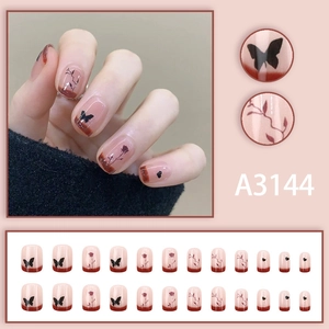 Short round French press-on nails with red butterfly and rose designs in a 24-piece set