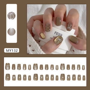 Mocha press-on nails with cat eye finish, white bow designs and polka dots, model MY132