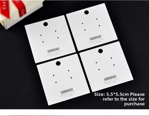 Macro view of white square S925 silver jewelry display cards with gold foil lettering
