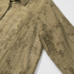 Detail view of the olive green floral jacquard fabric with vertical pleated texture