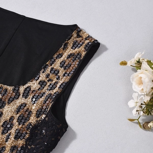 Detail of leopard print fabric with silver sequins and black lace trim on women's dress