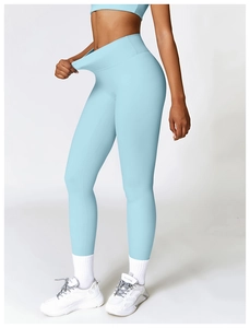Detail of high-elastic light blue yoga pants showing waist stretch and matte texture