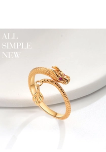 Detailed macro shot of golden dragon ring featuring red gem eyes and leaf pendant detail