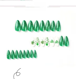 Detailed view of St. Patrick's Day press-on nails with green glitter, hearts and clover