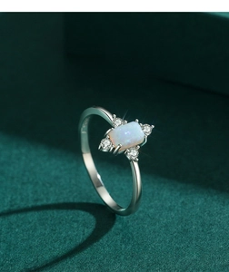 Macro detail of vintage S925 silver ring featuring rectangular opal and zircon stones