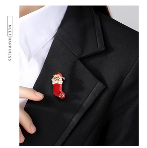 Close-up of a festive cat in a Christmas stocking brooch with sparkling crystals on a blazer